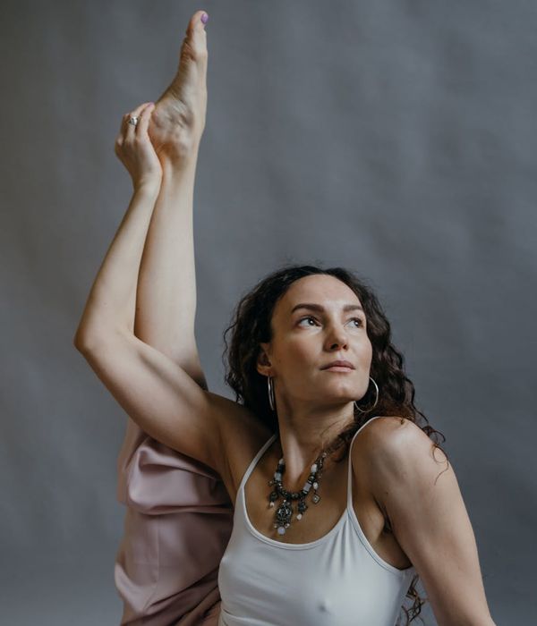 A woman in a calm, balanced pose, embodying harmony and focus.